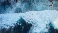 Beautiful texture of dark ocean waves with white foam. Drone filming breaking surf in Indian Ocean on Nusa Penida