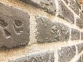 Beautiful texture of a decorative stone wall at an angle of building gray textured relief brick, stone of plaster with seams. The