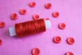 Beautiful texture with many round pink buttons for sewing, needlework and a coil of thread. Copy space. Flat lay. Pink, purple Royalty Free Stock Photo