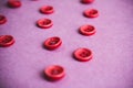 Beautiful texture with many round pink buttons for sewing, needlework. Copy space. Flat lay. Pink, purple background Royalty Free Stock Photo