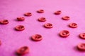 Beautiful texture with many round pink buttons for sewing, needlework. Copy space. Flat lay. Pink, purple background Royalty Free Stock Photo