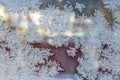 Beautiful texture pattern on frozen glass, natural beautiful snowflakes on frozen window in winter close up