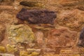 Beautiful textured surface of stone wall of scottish chapel close-up, warm tone Royalty Free Stock Photo