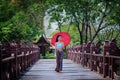 Beautiful Thai girl in traditional dress costume red umbrella as Royalty Free Stock Photo