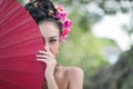 Beautiful Thai girl in traditional dress costume red umbrella, T Royalty Free Stock Photo