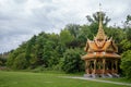 Beautiful Thai pavilion with green trees and cloudy sky Royalty Free Stock Photo