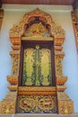 Beautiful Thai's style temple windows with golden craved buddha