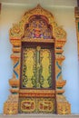 Beautiful Thai's style temple windows with golden craved buddha