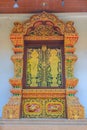 Beautiful Thai's style temple windows with golden craved buddha