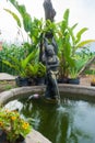 A beautiful Thai-style fairy statue standing in a pool of home g