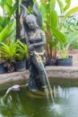 A beautiful Thai-style fairy statue standing in a pool of home g