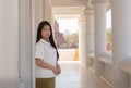 Beautiful thai woman in a white traditional thai dress is standing in white temple with smilingly face Royalty Free Stock Photo
