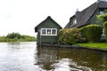 Beautiful thatched buildings in the famous village of Giethoorn in the Netherlands with water canals.