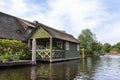 Beautiful thatched buildings in the famous village of Giethoorn in the Netherlands with water canals.