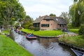 Beautiful thatched buildings in the famous village of Giethoorn in the Netherlands with water canals.