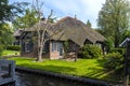 Beautiful thatched buildings in the famous village of Giethoorn in the Netherlands with water canals.