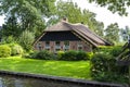 Beautiful thatched buildings in the famous village of Giethoorn in the Netherlands with water canals.