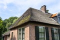 Beautiful thatched buildings in the famous village of Giethoorn in the Netherlands with water canals.