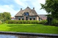 Beautiful thatched buildings in the famous village of Giethoorn in the Netherlands with water canals.