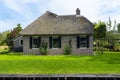 Beautiful thatched buildings in the famous village of Giethoorn in the Netherlands with water canals.