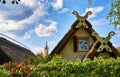 Beautiful thatched roofs of boat houses and Schwerin Castle in the background