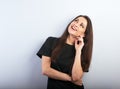 Beautiful thinking laughing woman with natural makeup and healthy shine skin looking up with hand under the face in casual black t Royalty Free Stock Photo