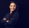 Beautiful thinking toothy laughing business woman with folded arms in blue shirt looking back on empty copy space black background Royalty Free Stock Photo