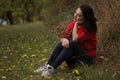 Beautiful thirty year old woman relaxes in the autumn park Royalty Free Stock Photo