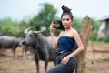 Beautiful Three Asian women dressed in Traditional costume with buffalo at farmland hand hold old radio transmitter Royalty Free Stock Photo