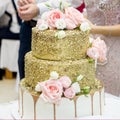 Chic beautiful wedding cake decorated with pink roses. Cutting cake