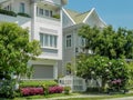 Beautiful three-story house with trees, and landscape design in the summer.