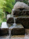 Beautiful three-tiered stone waterfall. Water flowing over rocks. Royalty Free Stock Photo