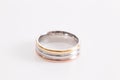 Beautiful three-tone ring Gold copper silver  three in one ring on the white background Royalty Free Stock Photo