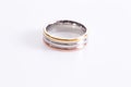 Beautiful three-tone ring Gold copper silver  three in one ring on the white background Royalty Free Stock Photo