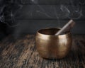 Beautiful tibetan singing bowl with stick on itself Royalty Free Stock Photo