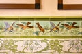 Beautiful tiles with painted images of sparrows in the nature