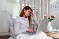 Beautiful tired business woman is holding her head massaging her nose bridge while working on the laptop Royalty Free Stock Photo