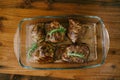 Beautiful toasted steaks in a glass plate on a wooden background, in their own juice and sprigs of rosemary. Royalty Free Stock Photo