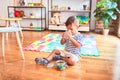 Beautiful toddler boy drinking glass of water at kindergarten Royalty Free Stock Photo