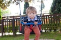 Beautiful toddler boy having fun on swing Royalty Free Stock Photo