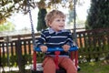 Beautiful toddler boy having fun on swing Royalty Free Stock Photo
