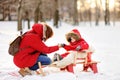 Beautiful toddler boy and his mother having fun in winter Royalty Free Stock Photo