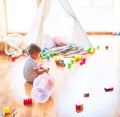 Beautiful toddler boy playing with basketball ball and plastic basket at kindergarten Royalty Free Stock Photo