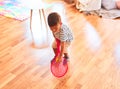 Beautiful toddler boy playing tennis with red racket and ball at kindergarten Royalty Free Stock Photo