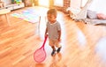 Beautiful toddler boy playing tennis with red racket and ball at kindergarten Royalty Free Stock Photo