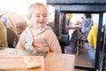 Beautiful toddler child girl sitting on baby highchair laughing