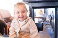 Beautiful toddler child girl sitting on baby highchair laughing