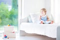 Beautiful toddler girl with curly hair reading book Royalty Free Stock Photo