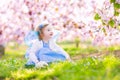 Beautiful toddler girl in fairy costume in fruit garden