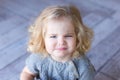 Beautiful toddler girl frowns. ÃÂ¡lose-up portrait. Indoor photo.